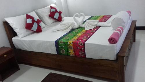 a bed with christmas presents on top of it at The Green Village Dambulla in Dambulla