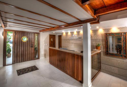 a lobby with a bar in a house at Casa Verano Beach Hotel - Adults Only in Santa Marta