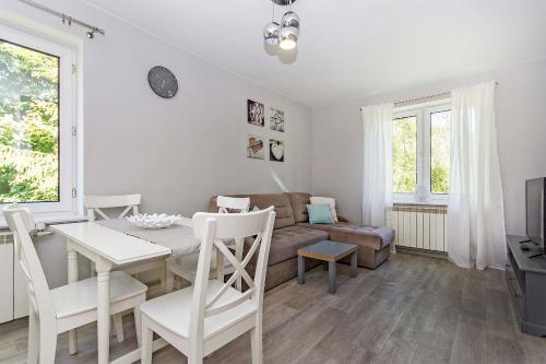 a living room with a table and a couch at Green Park Rentyear Apartments in Sopot