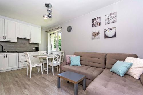 a living room with a couch and a table at Green Park Rentyear Apartments in Sopot