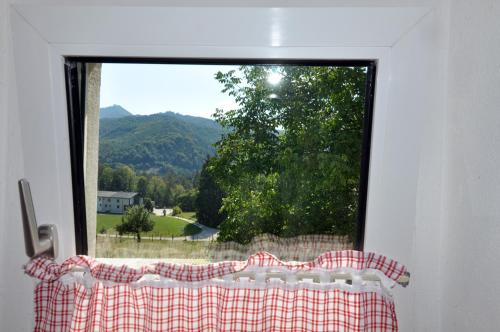a window with a view of a mountain view at Mostheuriger Steyrdurchbruchalm in Leonstein