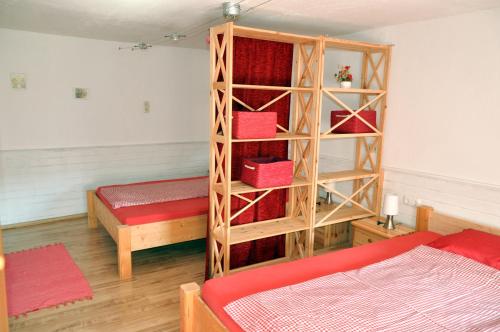 a bedroom with a bed and a book shelf at Mostheuriger Steyrdurchbruchalm in Leonstein