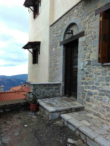 a building with a door and steps in front of it at Holiday Apartments in Arachova in Arachova