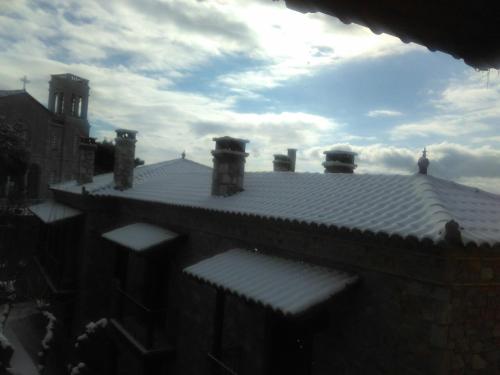 a roof of a building with a clock tower at Holiday Apartments in Arachova in Arachova