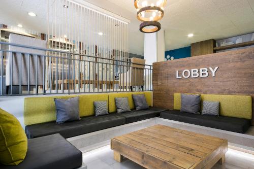 a lobby with a couch and a coffee table at Madrid Airport Suites, Affiliated by Meliá in Madrid