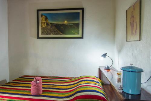 a bedroom with a bed with a towel on a table at Hotel Mon Ami in El Remate