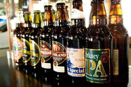 a group of bottles of beer sitting on a table at Merkister Hotel in Harray