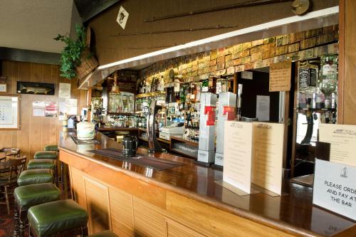 a bar with a lot of bottles of alcohol at Merkister Hotel in Harray