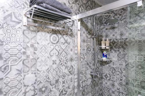 baño con ducha y puerta de cristal en Wuhan Wuchang·Happy Valley· Locals Apartment 00121930, en Wuhan