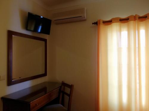 TV a/nebo společenská místnost v ubytování Residencial Idalio
