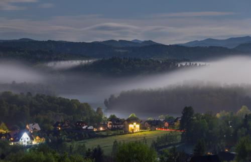 a small town in the mountains with fog in the valley at Nad Bieszczadzkim Morzem in Polańczyk