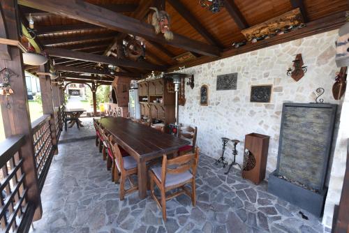 a dining room with a wooden table and chairs at Casa Andrei in Orşova