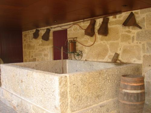 a large stone tub in a room with a barrel at Casa da Ponte do Porto in Amares