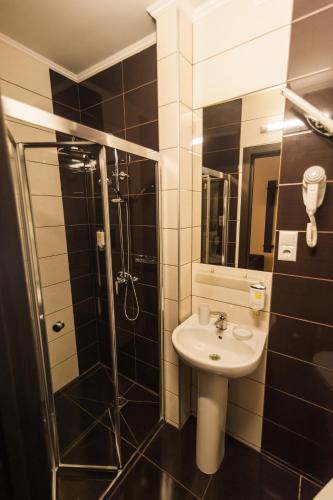 a bathroom with a sink and a shower at Rhombus Hotel in Luts'k