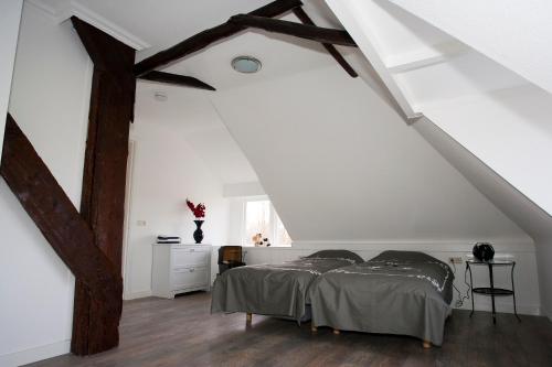 a bedroom with two beds in a attic at Shepherds House B&B in Limmen