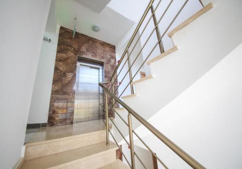 a staircase in a house with a stone wall at Greenland Premium Residance in North Nicosia