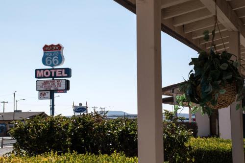 a motel sign in front of a gas station at Historic Route 66 Motel in Seligman