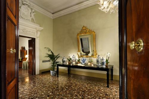 a room with a table with vases on it at Al Palazzo del Marchese di Camugliano Residenza d'Epoca in Florence