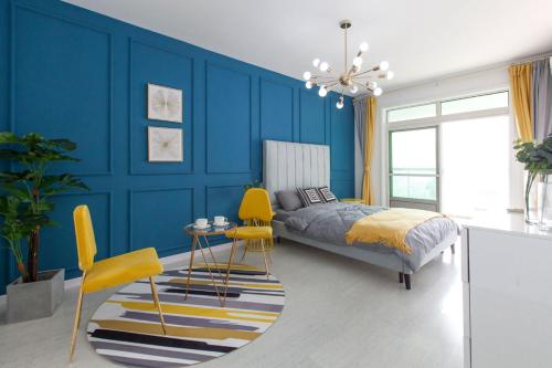 a blue bedroom with a bed and a table and chairs at Wuhan Wuchang·Wuchang River Beach· Locals Apartment 00139250 in Wuhan