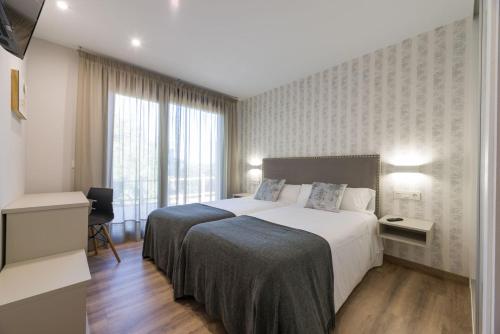 Katil atau katil-katil dalam bilik di Hotel A Curuxa Wellness