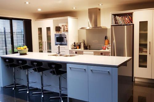 a kitchen with a large island with a counter top at Papamoa Retreat in Tauranga