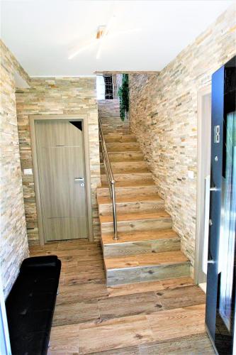 a staircase in a building with a brick wall at Villa Summer dream with heated pool, sauna and jacuzzi in Malinska