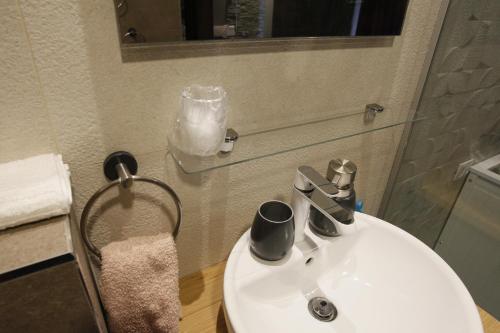 a bathroom with a white sink and a mirror at Villa Summer dream with heated pool, sauna and jacuzzi in Malinska