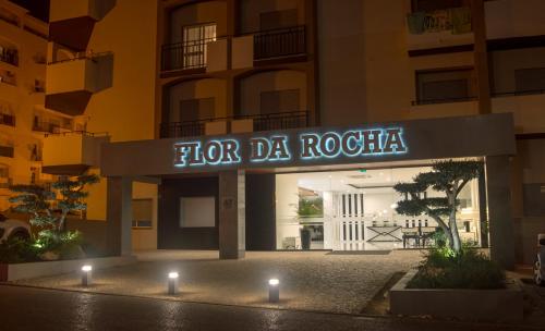 a sign for a hotel in front of a building at Flor Da Rocha in Portimão