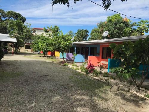 a house with colorful furniture in front of it at Cabinas Surf Side in Cahuita