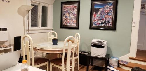 a dining room with a table and chairs and a printer at MyStayLA in Los Angeles