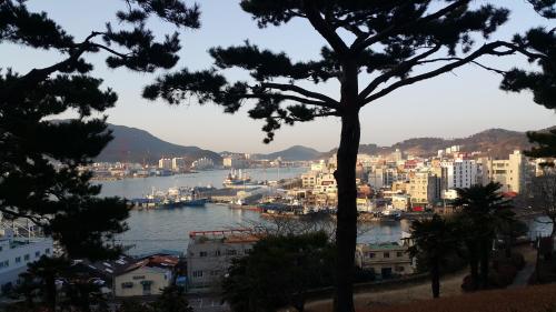 Blick auf eine Stadt mit Fluss und Gebäuden in der Unterkunft Kangguan Guesthouse in Tongyeong