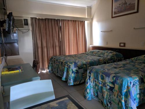 
a hotel room with two beds and a television at Best One Motel in Rockhampton

