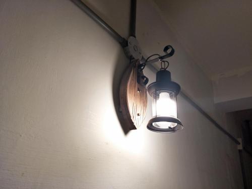 a light hanging from a wall in a room at MILU Backpacker Hostel in Puli