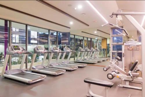 a gym with a row of treadms and machines at The Robertson KL in Kuala Lumpur