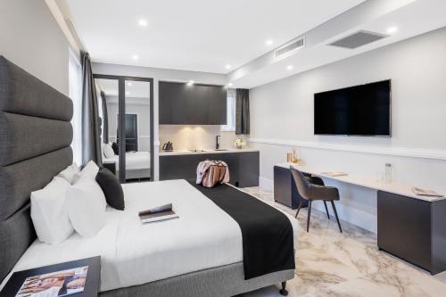 a hotel room with two beds and a television at Holiday Inn & Suites - Parramatta Marsden Street, an IHG Hotel in Sydney
