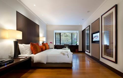 a bedroom with a large bed and a television at The Saujana Kuala Lumpur in Subang Jaya