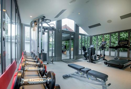 a gym with a row of treadmills and machines at M Social Singapore in Singapore