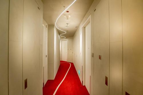 a hallway with a red carpet in a building at M Social Singapore in Singapore