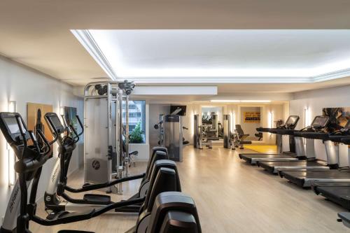a gym with a bunch of treadmills and ellipticals at Hyatt Regency Orlando International Airport Hotel in Orlando