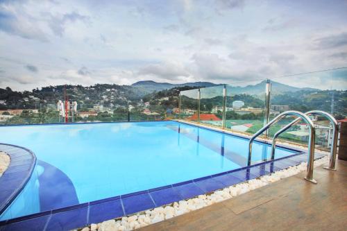 a large swimming pool with a view of a city at Sevana City Hotel in Kandy