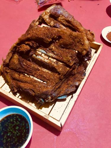 a cake on a plate on a pink table at Lantern Hotel in Hohhot