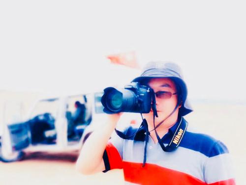 a person taking a picture with a camera at Lantern Hotel in Hohhot