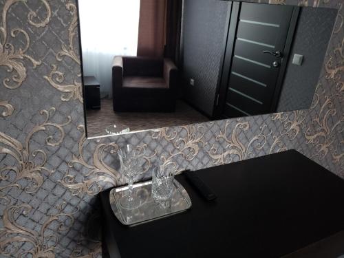 a bathroom with a sink and a mirror at Rhombus Hotel in Luts'k