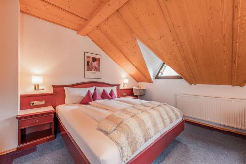 a bedroom with a large bed and wooden ceilings at Alpin Apart Maurer in Längenfeld
