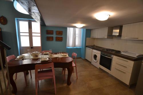a kitchen with a table with chairs and a dining room at Valletta Dream Suites in Valletta
