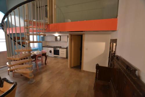 a living room with a staircase and a dining room at Valletta Dream Suites in Valletta