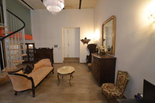a living room with a couch and a mirror at Valletta Dream Suites in Valletta