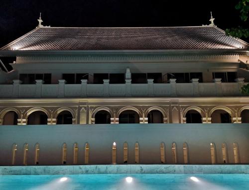 a building with a swimming pool in front of it at The Inside House in Chiang Mai