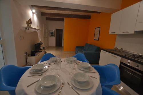 a table with plates and glasses on it in a kitchen at Valletta Dream Suites in Valletta