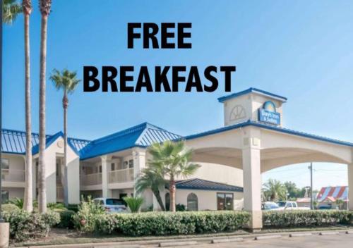 a free breakfast sign in front of a hotel at Days Inn & Suites by Wyndham Winnie in Winnie